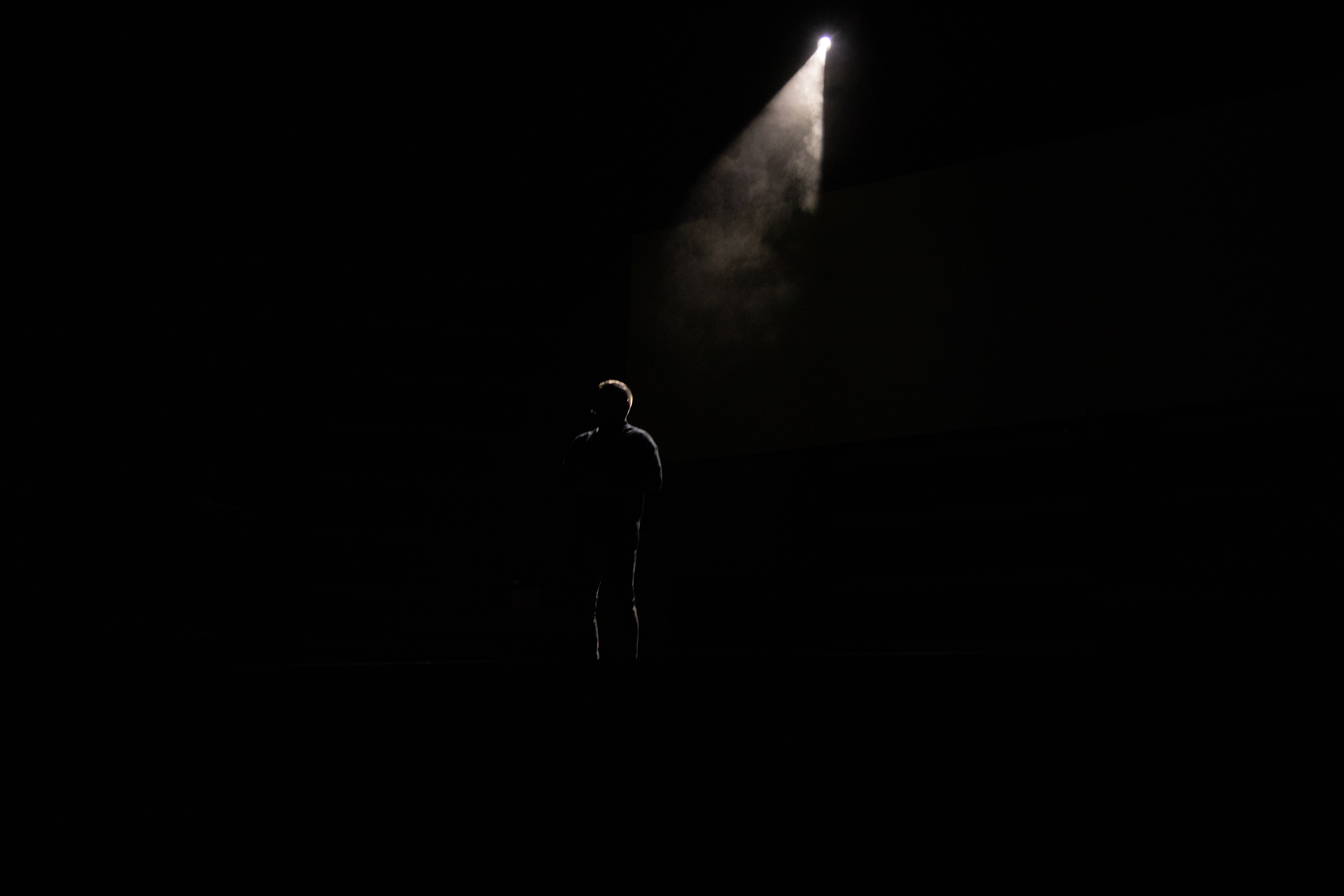 silhouette of person standing on stage
